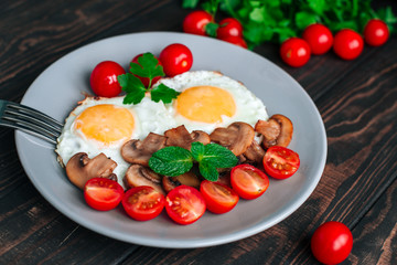 vegetarian Breakfast with eggs, tomatoes , mushrooms and herbs top view