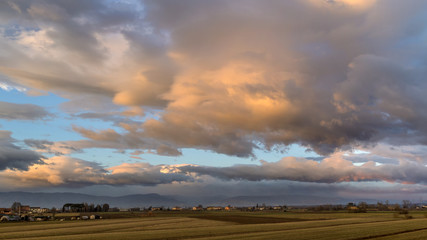 Colorful panoramic sunset over the countryside and Apennine mountain range between Tuscany and Emilia Romagna, central Italy