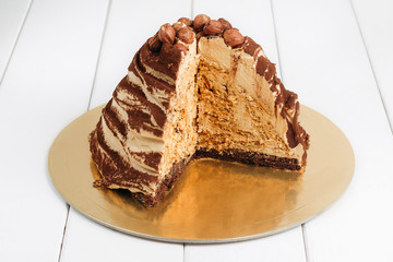 Cake with nuts on a white wooden table