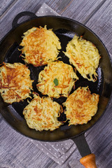 Potato Pancakes. Vegetable fritters. Latkes in frying pan. View from above, top studio shot