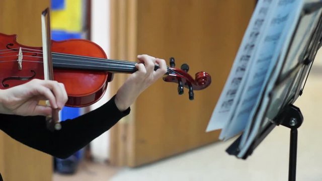 Talented schoolgirl playing the violin during school fair