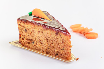 Slice of a carrot cake on white background