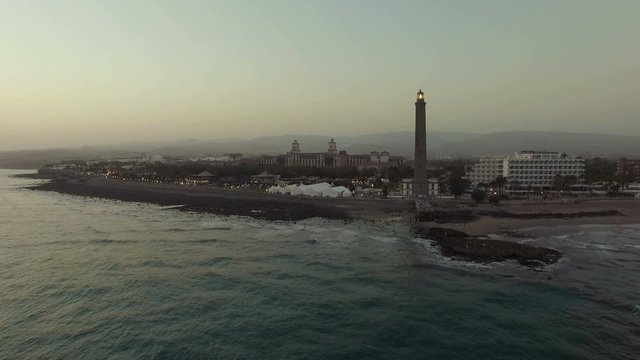 Aerial evening scene of Gran Canaria coast with resort and Maspalomas Lighthouse