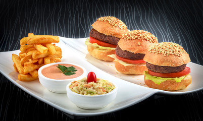 Burgers with french fries and coleslaw salad