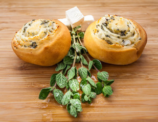 Cheesy pastries with herbs on a table