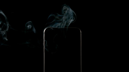 Smoke from smartphone on a black background - Center