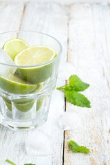 Fototapeta premium ingredients for a mojito in a glass on a light background.