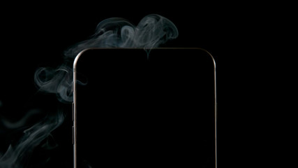 Smoke from smartphone on a black background - Close up - 138817326