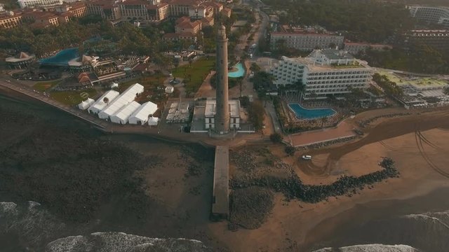 Aerial panorama of resort town with Maspalomas Lighthouse on the ocean coast of Gran Canaria