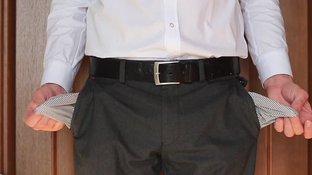 Businessman demonstrates his empty pockets