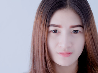 Obraz premium Portrait of Asian woman in white vest, expressing the idea of broken heart and sadness. hopeless and await, concept. white tone.