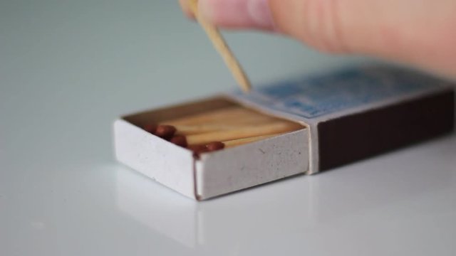 Taking a match from a box close up