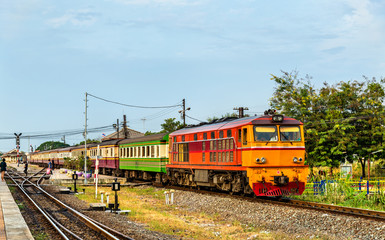 Naklejka premium Passenger train for Bangkok departs from Ayutthaya station