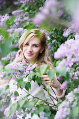 Fototapeta premium woman in blossoming lilacs
