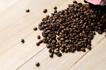  bag with coffee beans on a wooden background