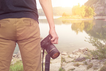 photographer with camera mountain lake