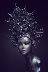 Mannequin in metallic headwear with chains
