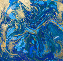 Blue and gold liquid texture. Hand drawn marbling background. Ink marble abstract pattern