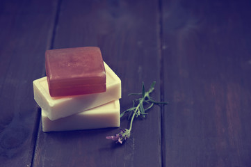 Natural soap bars over dark wooden background. Spa concept.