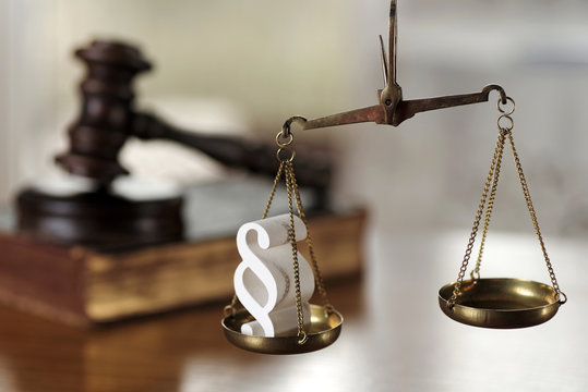 Law composition with scale and gavel on  old brown leather book