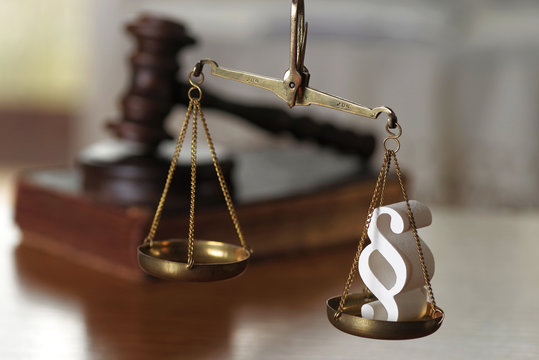 Law composition with scale and gavel on  old brown leather book