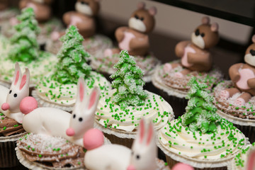 Row of cupcakes with Christmas trees on top and selective focus