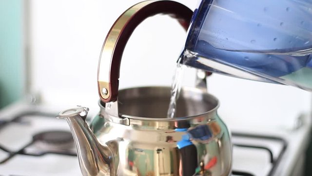 Pouring water into a chrome pot