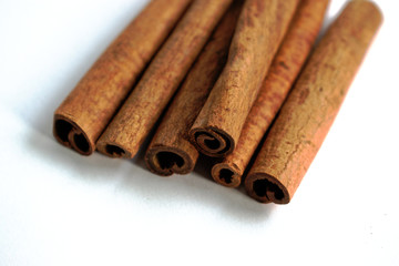 Closeup of cinnamon sticks on a white background