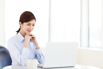 Young  business woman with laptop in the office