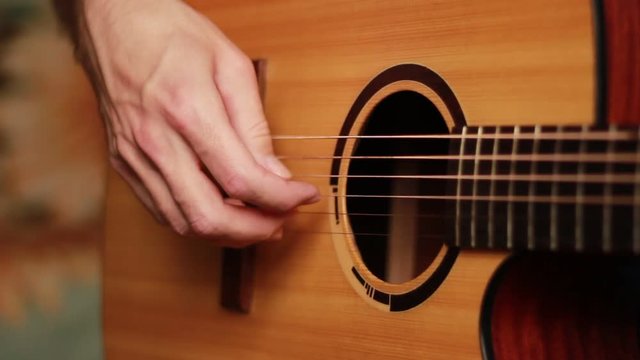 Fingers on the guitar's strings