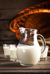 Goat milk in glasses, vintage wooden background, selective focus