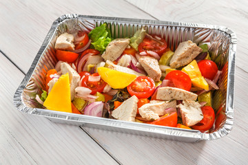 Healthy food in boxes, diet concept. Steamed turkey with vegetables