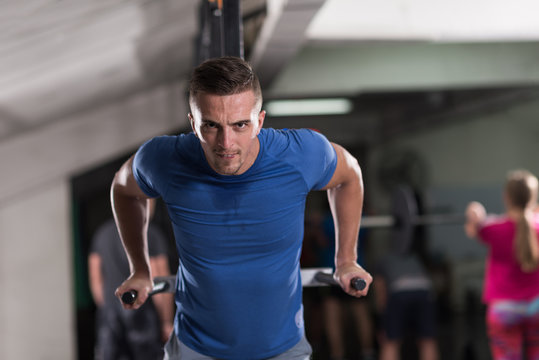 man doing exercises parallel bars