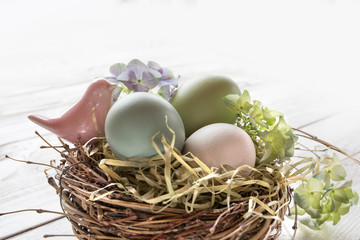 Fototapeta na wymiar Easter eggs in a nest of straw