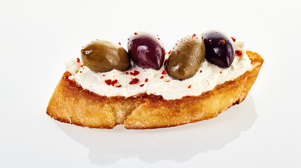 Olive canape seasoned with red cayenne pepper