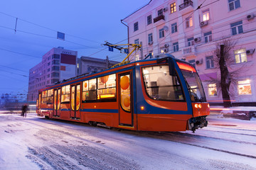 Fototapeta na wymiar Tram in the street of winter city of Khabarovsk