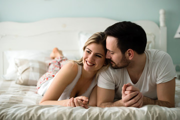 Couple in love wearing pajamas lying in bed