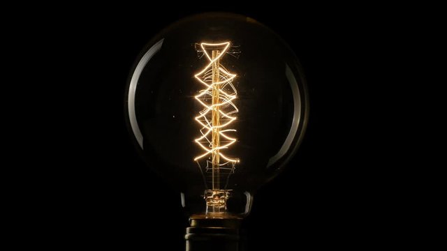 Vintage Edison light bulb flickering.  4K, UHD 