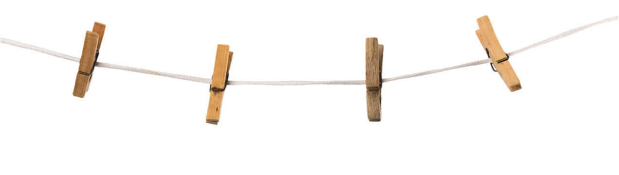 Old wooden clothespins on a rope isolated on  background
