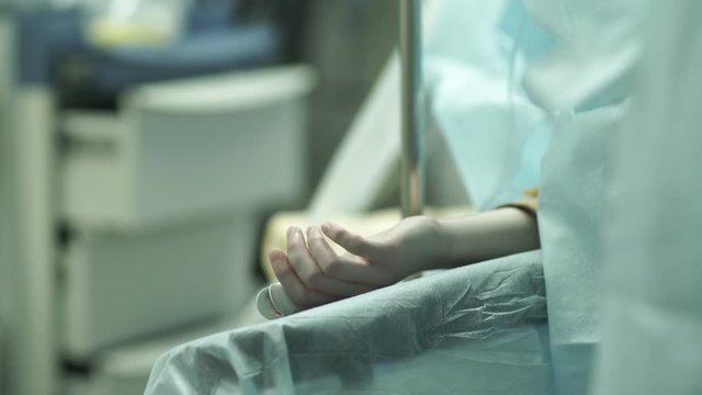 The patient's hand on the operating table