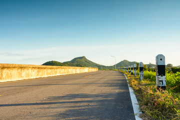 Road curve to mountain with sunshine