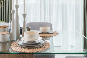 glass dining table with table set in modern dining r