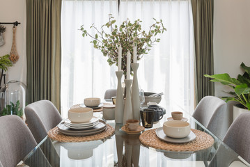 glass dining table with table set in modern dining r