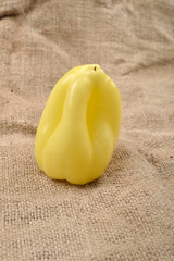 Sweet yellow pepper lying on jute canvas background. Concept of healthy food, bio from countryside