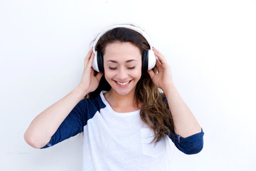 happy young woman holding headphones and listening to music