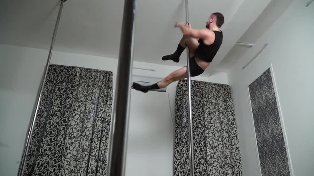 Dancer in a revealing costume tumbling pole dance