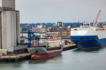 Huge and Small Freighter in Port