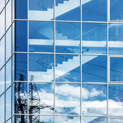 Modern business industrial architecture. Close-up photo of modern office building of steel and glass.