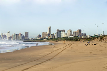Sandy Beach Ocean and Waves Against City Skyline