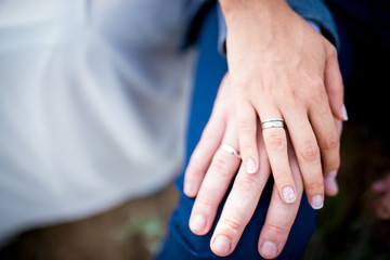 Hands of married couple with golden rings close up